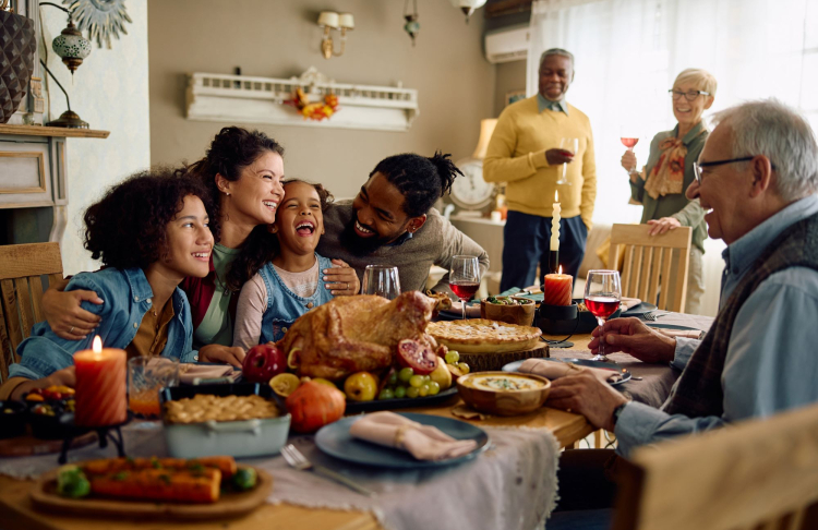 A family enjoying Thanksgiving with a turkey.